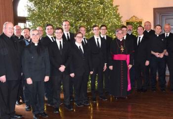 Bishop Schlert, center, celebrates Christmas with seminarians and their pastors along with diocesan officials at Lehigh Country Club.