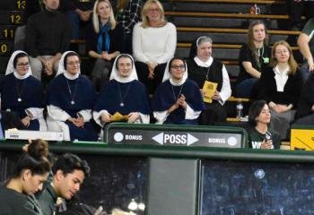 Sister alumnae and students gather in Rockne Hall for Eucharistic Adoration.