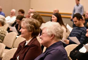 Men and women attend the Kraft Lecture as part of Heritage Week at DeSales University, Center Valley.
