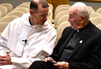 Father Kraft, left, talks with Father Alexander Pocetto, senior Salesian scholar at the Salesian Center for Faith and Culture, before the lecture.