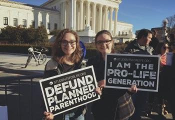 Twin sisters Trista, left, and Carlee Mayo, parishioners of Holy Rosary, Reading, who traveled with the group from St. Benedict, Mohnton, show their support for life and defunding Planned Parenthood. (Photo courtesy of Carlee Mayo)