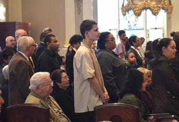 Catechumens stand as their names are called during the Act of Election.