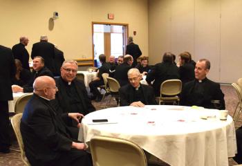 Bishop William Waltersheid, left, chats with, from left: Msgr. Gerald Gobitas, Diocesan chancellor and secretary for clergy; Msgr. Walter Scheaffer, pastor of St. Mary, Kutztown; and Father Michael Mullins, pastor of St. Paul, Allentown.