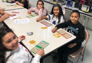 Our Lady Help of Christians (OLHC) School, Allentown celebrates Catholic school students with games and activities. Enjoying a game of bingo are, from left, Aleisha Chila, Adrianna Dergam, Jujie Khori and Kayla Muniz. (Photo courtesy of Michael Hillegas)