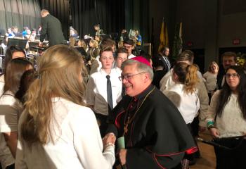Bishop Alfred Schlert congratulates students participating in the 44th Annual Diocesan Music Festival Jan. 27 at Allentown Central Catholic High School. Performances were presented by band and choir members from the six diocesan high schools in the Diocese of Allentown. (Photo courtesy of Jessica Erdis)