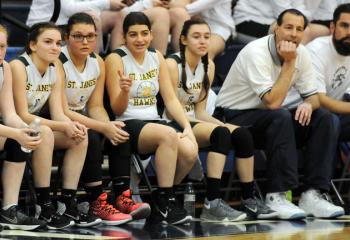 Players and coaches from St. Jane Frances de Chantal, Easton watch game action with St. Thomas More during semi-finals March 4 at St. Joseph the Worker.