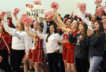 Fans cheer the St. Thomas More boys’ team after they win the grade school boys’ championship.  
