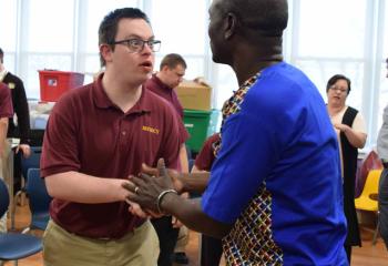 Thomas Awiapo meets James Hebert after talking about his struggle for survival while growing up in a small African village in Ghana. (Photo by John Simitz)