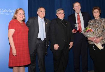 The first-time award for Lifetime Service to the Catholic Charities Gala was presented to Paul and Patty Huck, right, who have served on the gala committee since its inception. At left are this year’s chairpersons Evelyn and Anthony Carfagno, and Bishop Schlert.