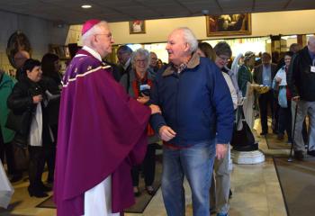 Archbishop Joseph Kurtz greets faithful after the Lenten Mass.