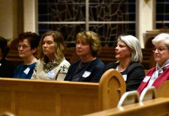 Members of the parish’s Addiction Ministry Team listen to speakers to gain better knowledge in helping people to seek recovery.