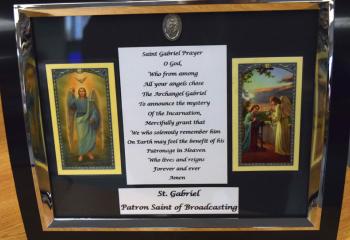 A plaque of St. Gabriel, patron saint of broadcasting, sits on the WSAS (St. Ann School) newsdesk. 