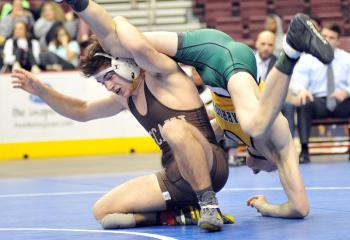 Becahi’s Cole Handlovic, left, lifts Job Chishko, Penn Trafford High School, Harrison City, during the 145-pound bout for fifth place during the PIAA Class AAA wrestling tournament. Chishko defeated Handlovic 8-3. 