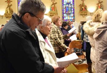 Those gathered lift their voices in song at the evening liturgy.