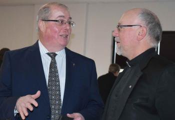 Matt Lloyd, left, co-chairperson of BAA in Berks County, talks with Msgr. Edward Domin, pastor of St. Catharine of Siena. 