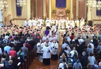 Seminarians, priests and deacons participate in the recessional after the Chrism Mass celebrated at the cathedral.