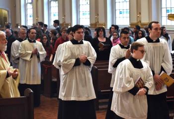 Diocesan seminarians process into the cathedral for the Chrism Mass, a service that was restored in 1967 and dates back to the early 200s.