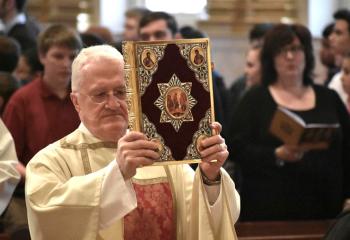 Deacon Gerald Schmidt, assigned to St. Theresa of the Child Jesus, Hellertown, carries the Book of Gospels during the procession into the cathedral.