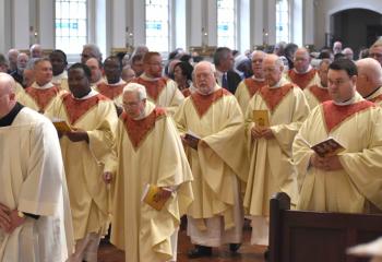 Diocesan priests process into the cathedral for the Chrism Mass, where they renew their promise to serve the Lord and his Church and unite themselves more closely to Christ in the service of their people.