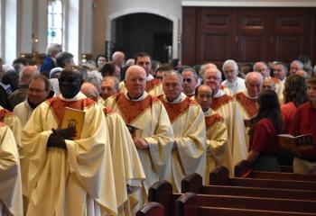 Diocesan priests enter the cathedral March 28 to celebrate the Chrism Mass.