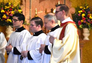 Diocesan seminarians who received the Call to Orders at the Chrism Mass are, from left, Giuseppe Esposito, Zachary Wehr, John Maria, and Deacon John Hutta.