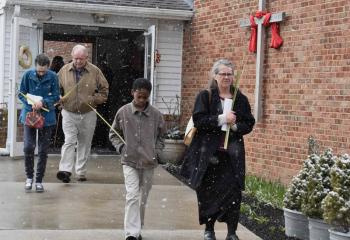 Faithful depart from St. Francis de Sales after observing Palm Sunday.