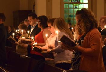 Faithful pray under candle light during the Service of Light at the Easter Vigil at the Cathedral of St. Catharine of Siena, Allentown.