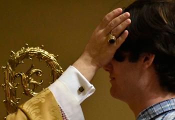 Noah McClain is anointed with Holy Chrism while receiving the Sacrament of Confirmation.