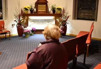 A woman spends time with the Blessed Sacrament resting on the Altar of Repose at Immaculate Conception BVM, Allentown after Holy Thursday services. The special altar is for the Communion hosts consecrated during the Mass of the Lord’s Supper and reserved for use on Good Friday.