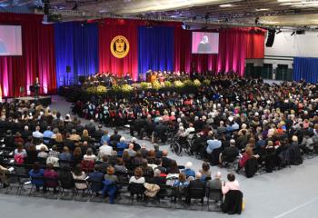 A crowd witnesses the inauguration of Father James Greenfield in Billera Hall.