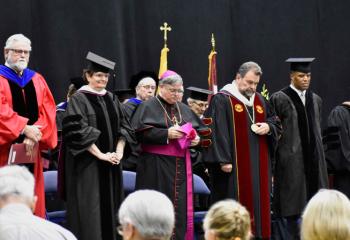 Taking the stage at Alvernia’s Commencement ceremony are, from left: Jerry Greiner, provost; Sister Marilisa da Silva, congregational minister for Bernardine Franciscan Sisters and Alvernia trustee; Bishop of Allentown Alfred Schlert; Dr. Thomas Flynn, Alvernia president; John Hope Bryant, commencement speaker, and founder, chairman and CEO of Operation HOPE; and Kevin St. Cyr, chairman of the Alvernia Board of Trustees.