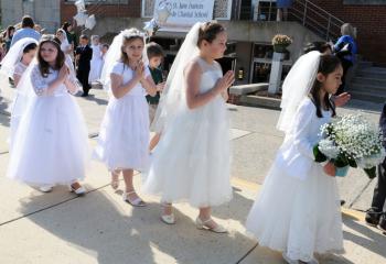 Students who received their First Holy Communion last month participate in the May Crowning procession.
