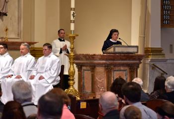 Sister Mary Jo Ely of the Sisters, Servants of the Immaculate Heart of Mary proclaims the first reading as lector. Listening are, from left, Deacon Giuseppe Esposito, Deacon John Maria, Deacon Zachary Wehr and Father Keith Mathur, director of the Diocesan Office for Divine Worship.