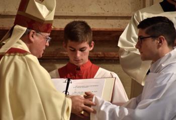 Candidate Giuseppe Esposito places his hands in Bishop Alfred Schlert’s hands as he makes his promise of obedience.