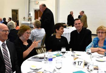 Father John Hutta, fourth from left, greets parishioners from Sacred Heart Palmerton, from left, Andy Krawchuk, Bonnie Lagorick, Sandy Miller and Barbara Shelton. (Photo by John Simitz)
