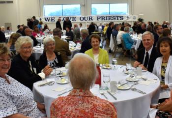 Guests enjoy the festive evening honoring the Diocese’s newest priest. (Photo by John Simitz)