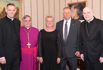 Gathering with Father Hutta, left, are, from left. Bishop Schlert, Father Hutta’s mother Diane Hutta, his father John Hutta and Bishop Cullen. 