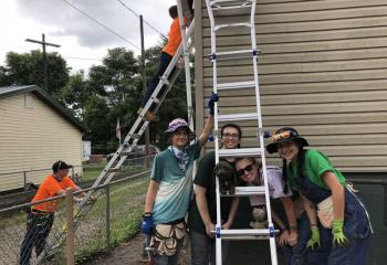 Members of the team worked to repair the damaged fascia boards and soffits on a home in West Virginia, from left: holding the ladder Shaughn Earle and at top of ladder John Tedeschi; front, Ryan Connolly, Julia Anderson, Mary Kate D’Arcy and Anna Julia Cividini. 