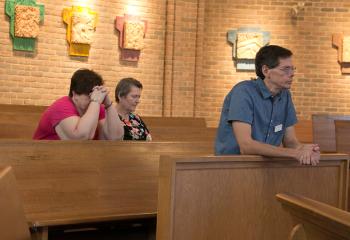 The faithful at St. Mary, Kutztown pray during the solemn day. (Photo by Sue Braff)