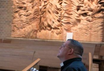 Father Martin Kern, pastor of St. Columbkill, Boyertown, prays during adoration at St. Mary. (Photo by Sue Braff)