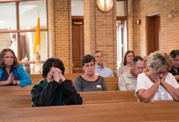 The faithful pray during adoration at St. Mary. (Photo by Sue Braff)