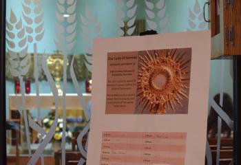 The adoration schedule at St. Ambrose. (Photo by John Simitz)