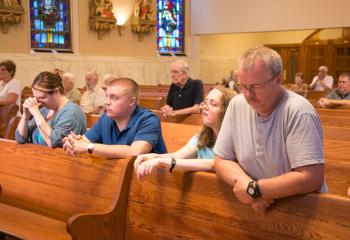 Parishioners pray at St. John the Baptist. (Photo by Sue Braff)