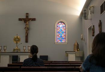 Parishioners pray before the Blessed Sacrament at Holy Guardian Angels, Reading. (Photo by Sue Braff)