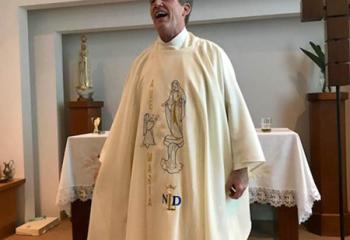Father Patrick Lamb smiles before celebrating the final Mass in the group’s hotel chapel in Fatima. He is wearing new vestments the group bought for him while in Lourdes. He was presented with the gift right before the Farewell Mass.