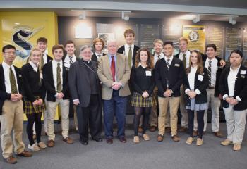 Students pose with John Post and Bishop Alfred Schlert, center.