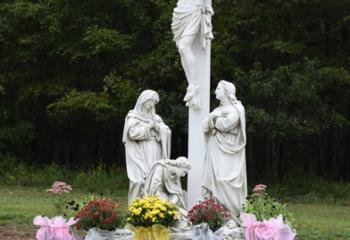 The crucifix scene statue with the Blessed Mother, Mary Magdalene, and St. John at the foot of the cross.