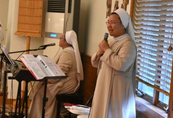 Leading the music for the Mass are, from left, SAHS Sister Mary Laudes Kim and SAHS Sister Mary John Park.