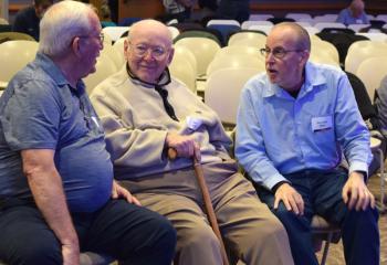 Enjoying conversation during the break are, from left: Frederick Yanity; Jack Huber; and Deacon John Mroz, assigned to St. Joseph, Jim Thorpe.
