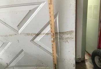 A yardstick measures 24 inches of water that swept through a home in Schuylkill County.